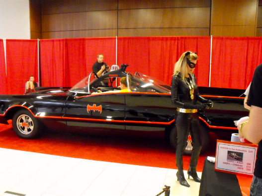 Watch out that kitty has claws! Batmobile attendant assists fans with ...