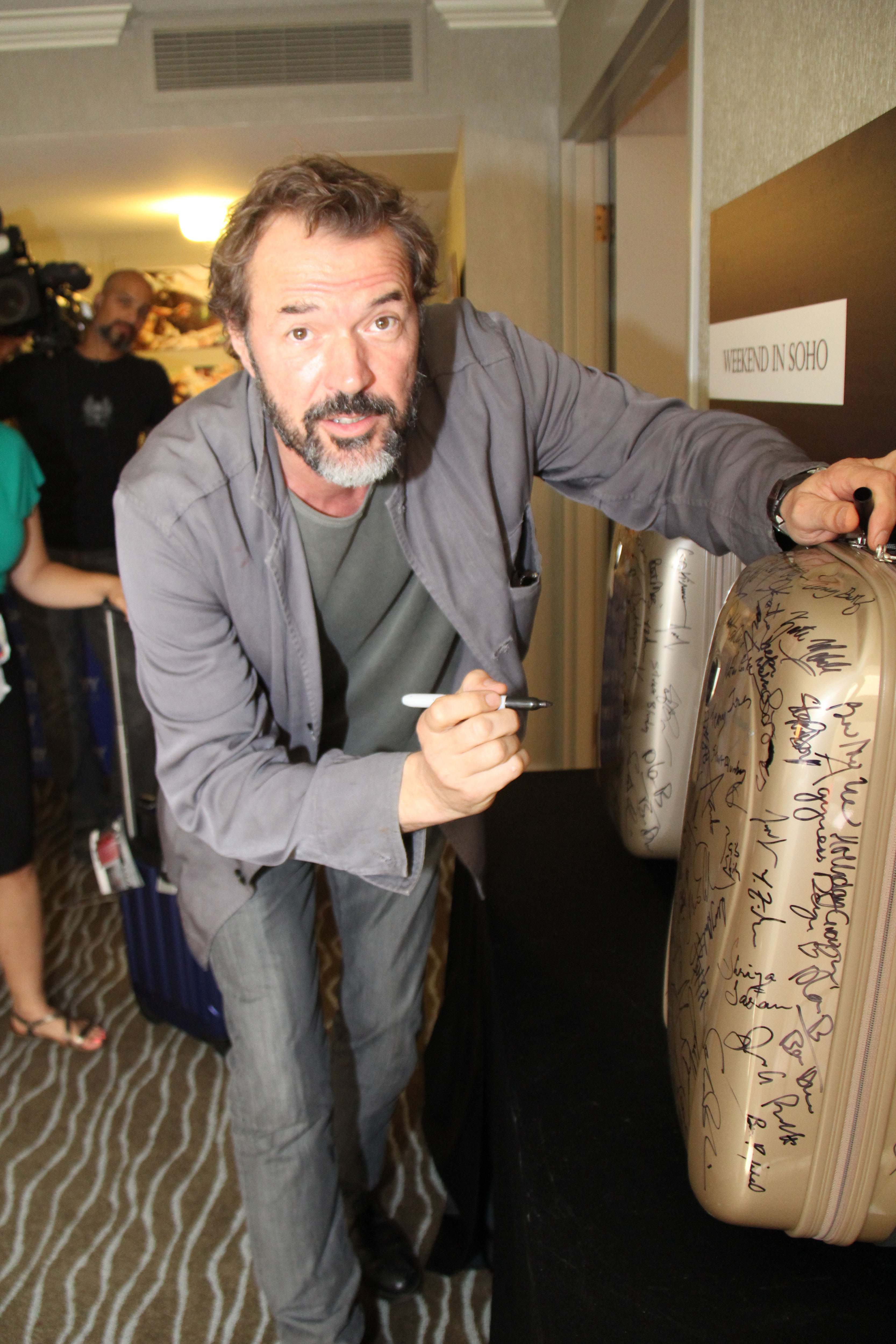 Sebastian Koch Signs Our Heys Suitcase For Charity Toronto International Film Festival Tiff